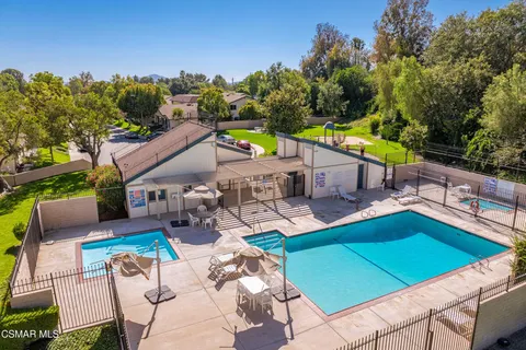 an aerial view of a house with swimming pool garden and patio