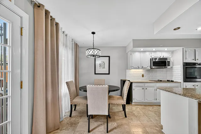 a view of a dining room with furniture and window