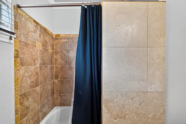 a bathroom with a shower and a sink