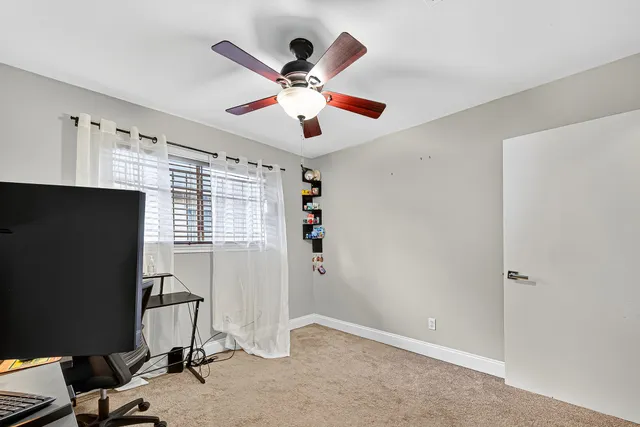 a view of a livingroom with a ceiling fan and a window
