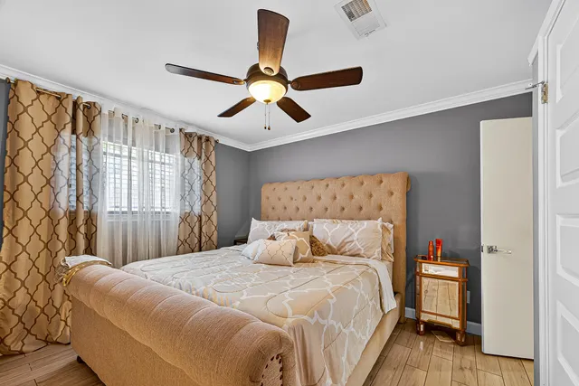 a bedroom with a large bed and a chandelier