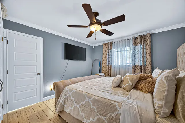 a bedroom with a bed and a flat tv screen