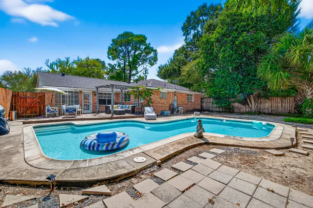 a swimming pool with outdoor seating and yard