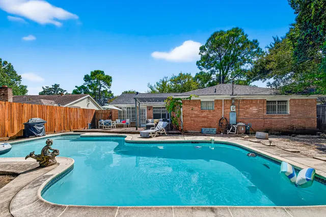 swimming pool view with a seating space