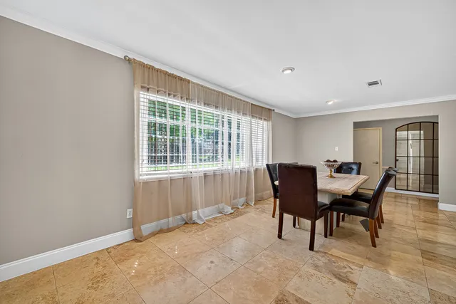 a view of a dining room with furniture and window