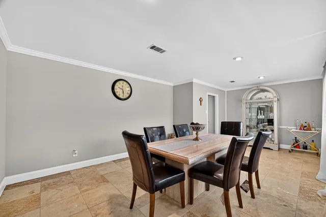 a view of a dining room and livingroom with furniture wooden floor and a rug