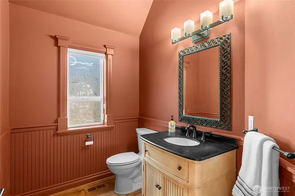 a bathroom with a sink a toilet and a mirror