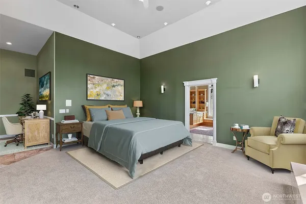 a spacious bedroom with a bed and a couch