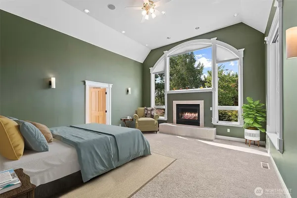 a spacious bedroom with a large bed and a fireplace