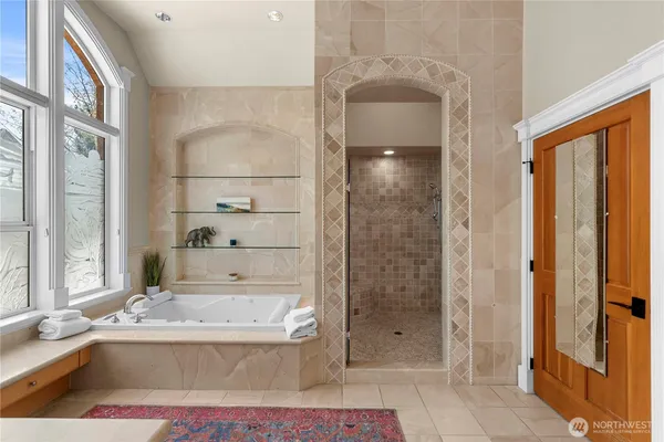 a bathroom with a tub shower and sink