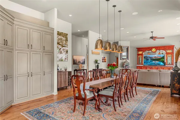 a view of a a dining room with furniture window and wooden floor