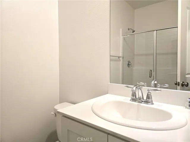 a white toilet sitting next to a bath tub
