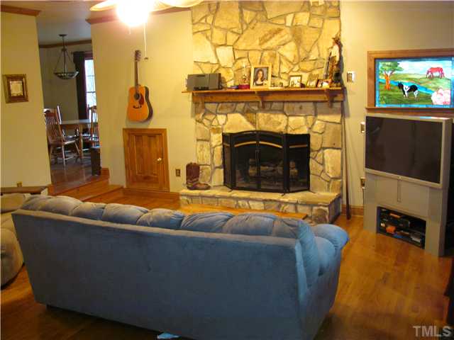 301 Pilot-Riley Road Zebulon, NC 27597 - Photo 11 of 15 a living room with furniture and a fireplace