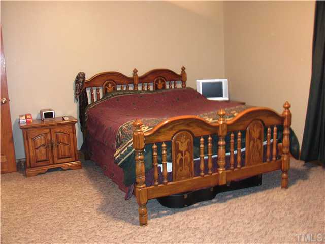 301 Pilot-Riley Road Zebulon, NC 27597 - Photo 13 of 15 a bedroom with a bed in it
