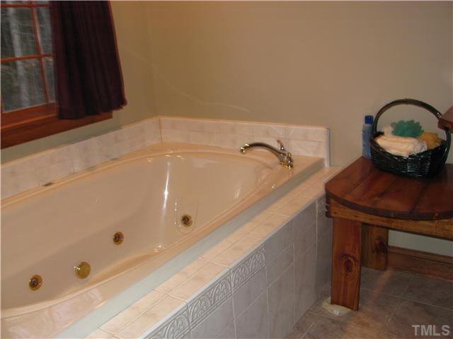 301 Pilot-Riley Road Zebulon, NC 27597 - Photo 14 of 15 a bathroom with a tub sink and vanity