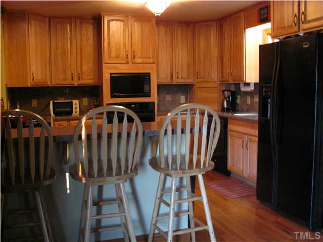 301 Pilot-Riley Road Zebulon, NC 27597 - Photo 5 of 15 a view of a kitchen with electric appliances