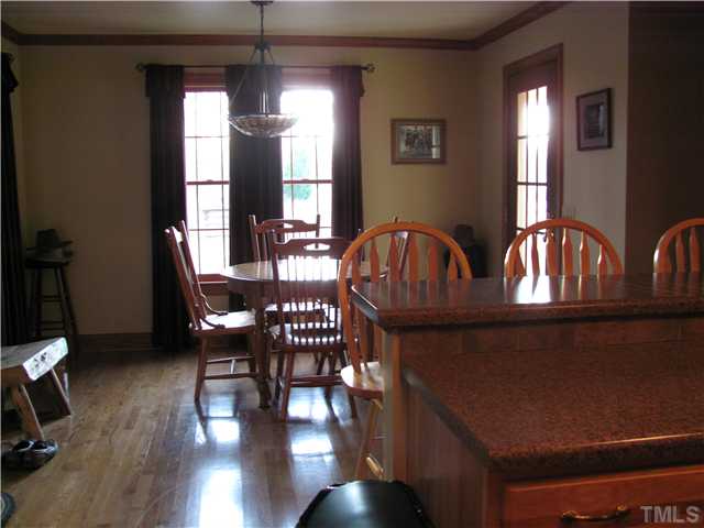 301 Pilot-Riley Road Zebulon, NC 27597 - Photo 8 of 15 a view of a dining room with furniture window and wooden floor