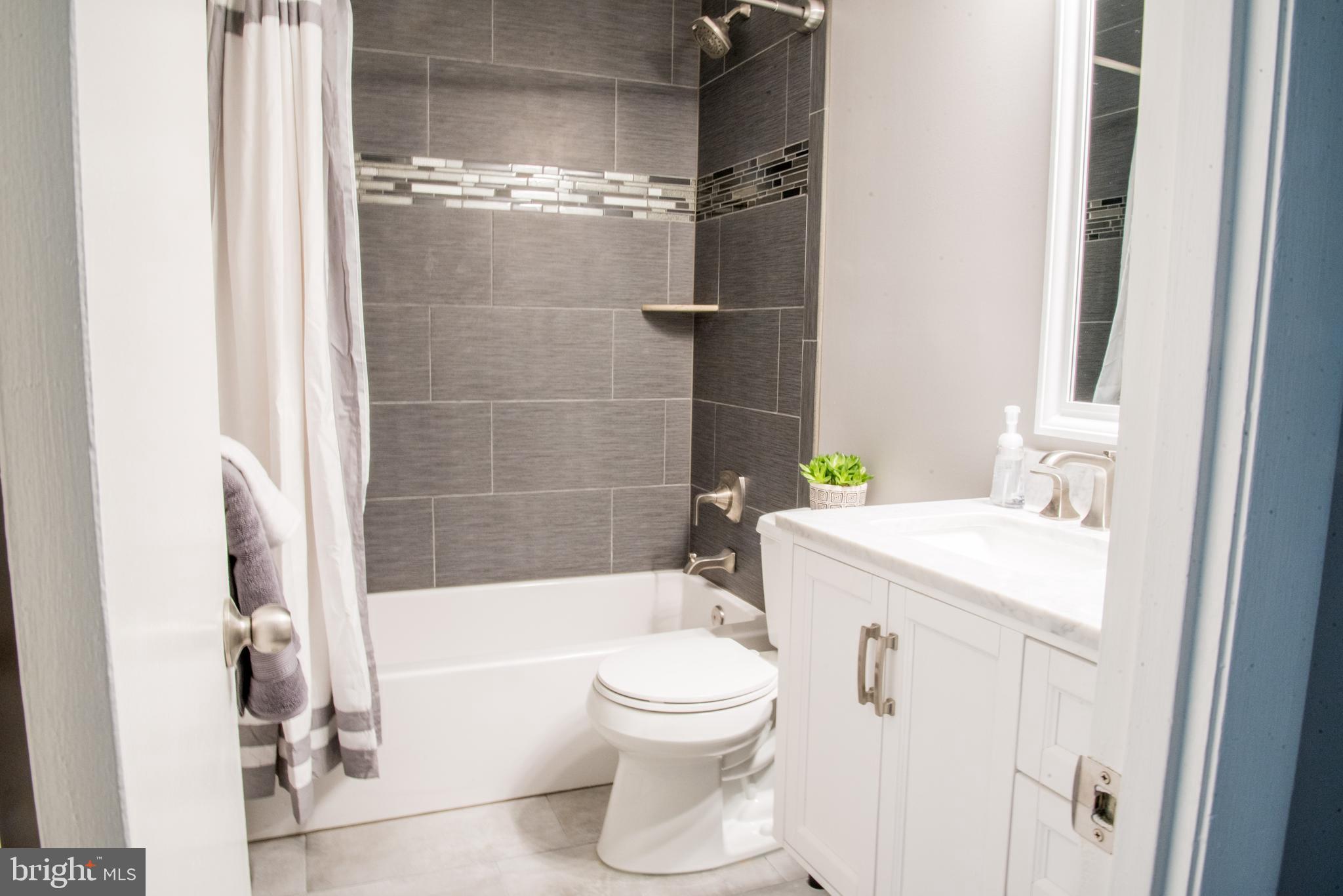 8521 Jenner Court Springfield, VA 22153 - Photo 12 of 20 Hall Bathroom. Floating Vanity with Marble Top.