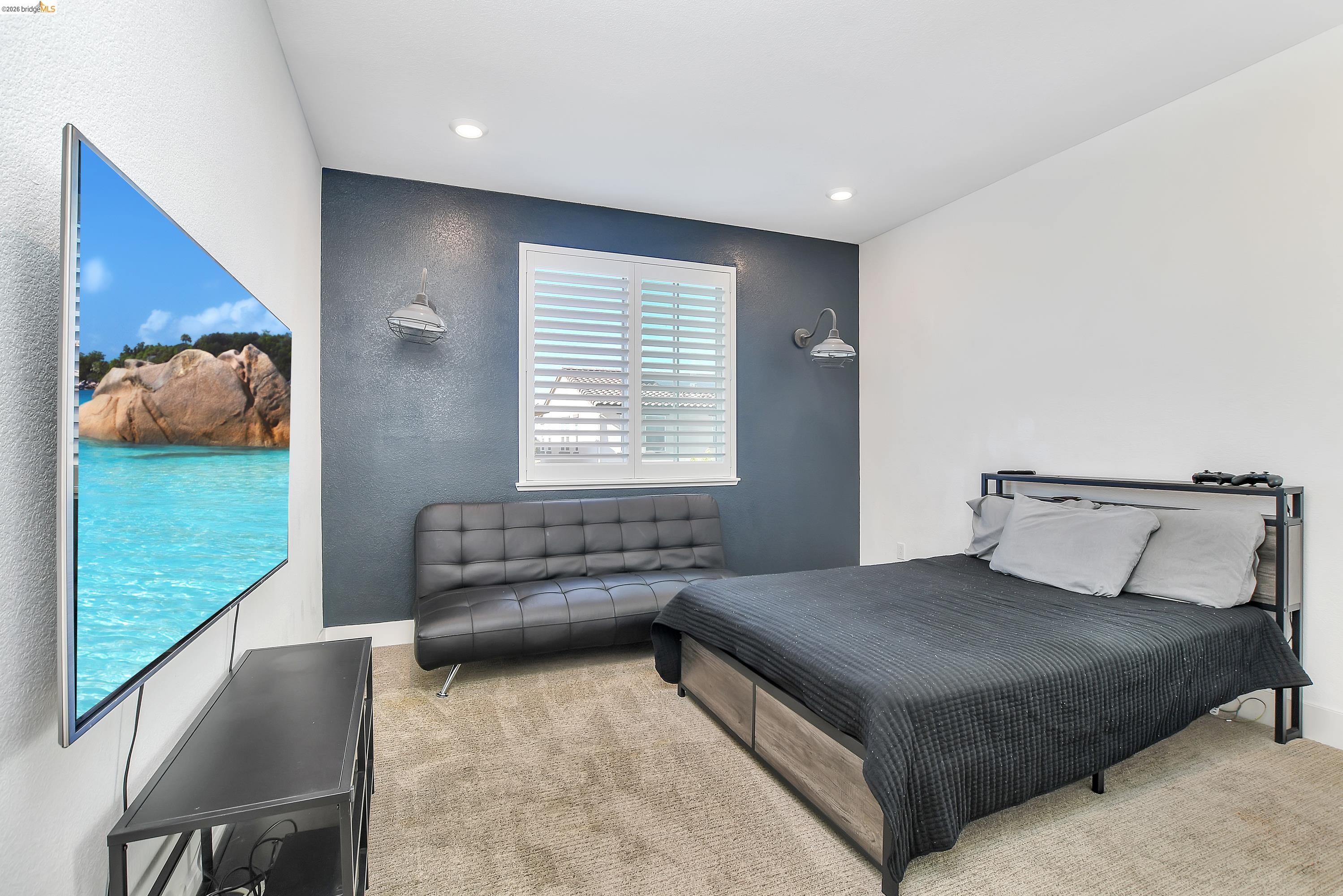829 Hardcastle Ranch Road Oakley, CA 94561 - Photo 20 of 41 Recessed lighting, window with plantation shutters, accent wall, wood-finish flooring, and wall-mounted sconces