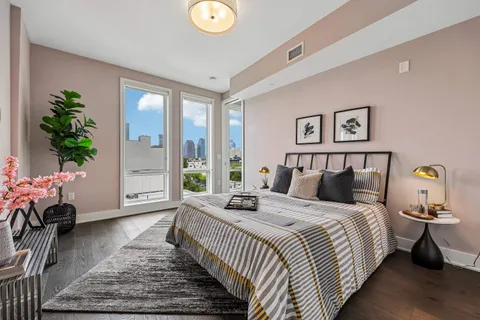 a bedroom with bed and wooden floor
