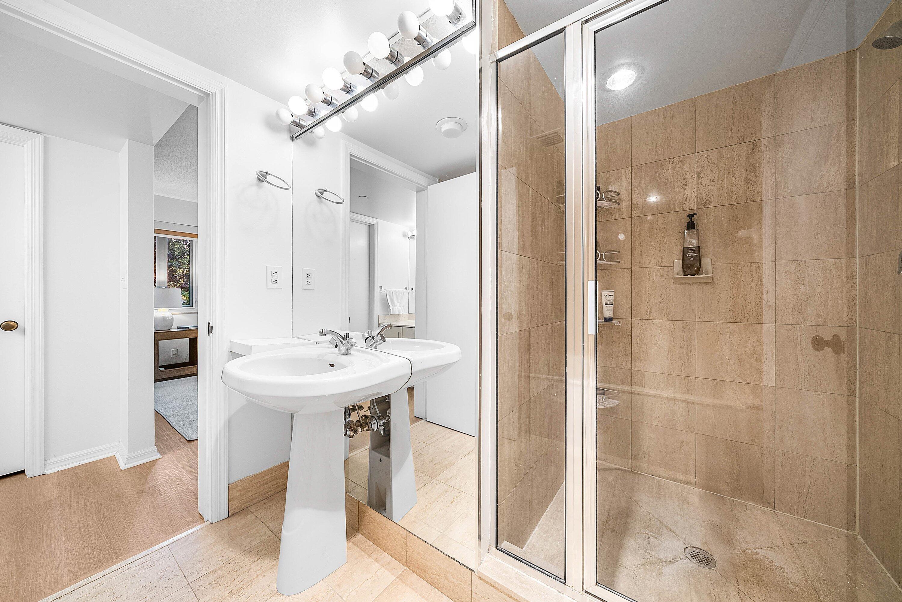 100 Southeast 5th Avenue, Unit 210 Boca Raton, FL 33432 - Photo 12 of 46 a bathroom with a sink a shower and a mirror