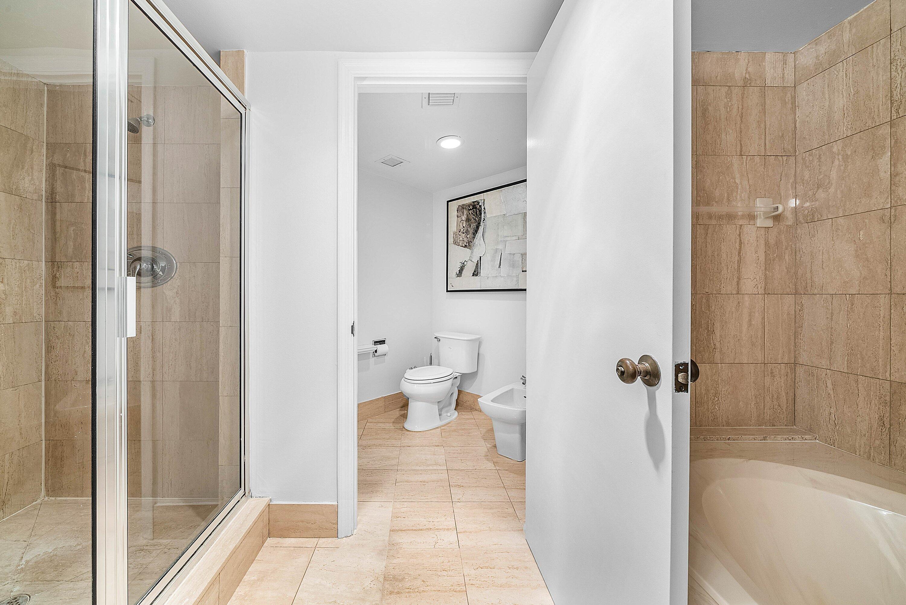 100 Southeast 5th Avenue, Unit 210 Boca Raton, FL 33432 - Photo 13 of 46 a bathroom with a toilet and a shower