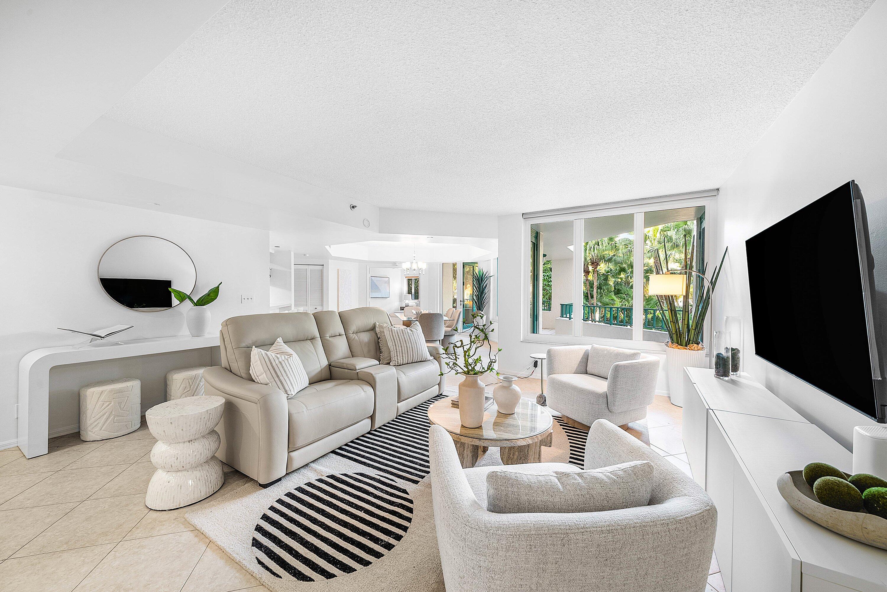 100 Southeast 5th Avenue, Unit 210 Boca Raton, FL 33432 - Photo 2 of 46 a living room with furniture and a flat screen tv