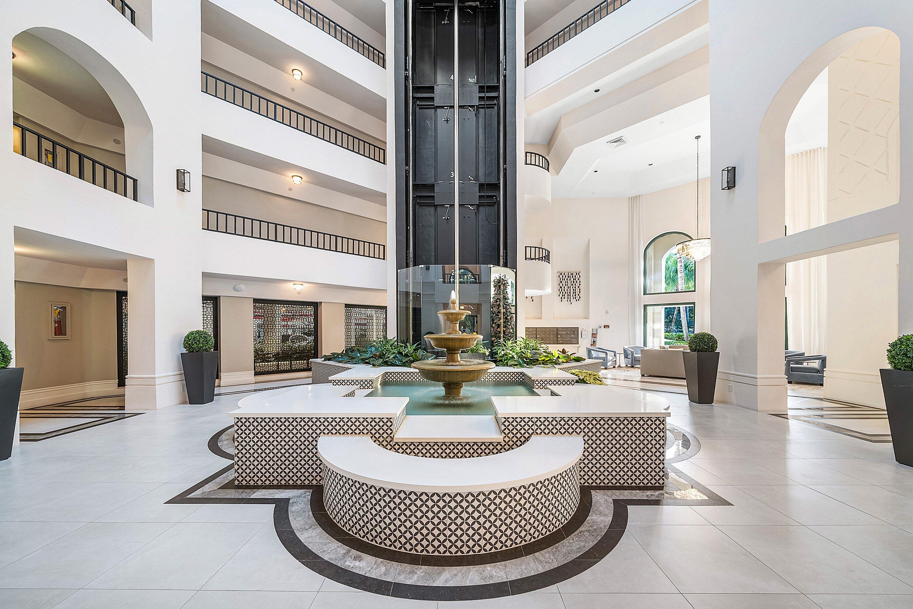100 Southeast 5th Avenue, Unit 210 Boca Raton, FL 33432 - Photo 23 of 46 a living room with fireplace furniture and a large window