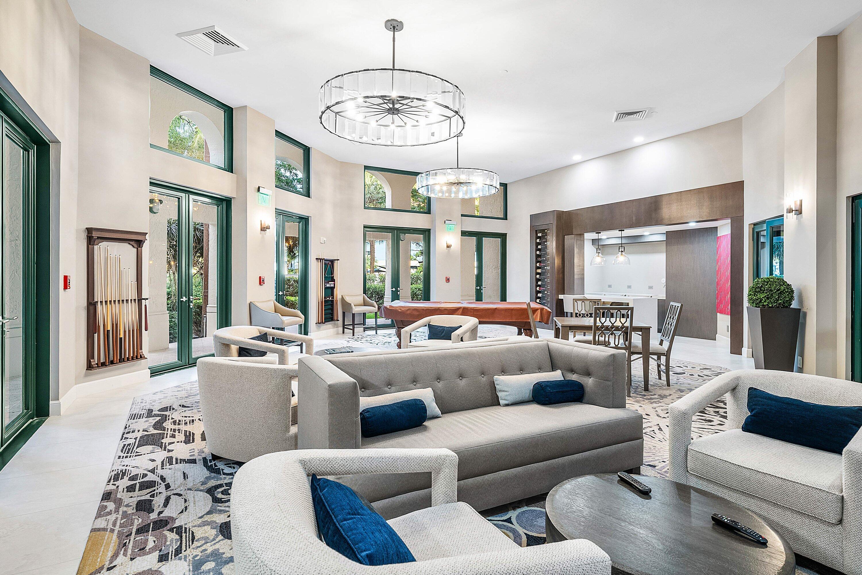 100 Southeast 5th Avenue, Unit 210 Boca Raton, FL 33432 - Photo 27 of 46 a living room with furniture chandelier and a large mirror