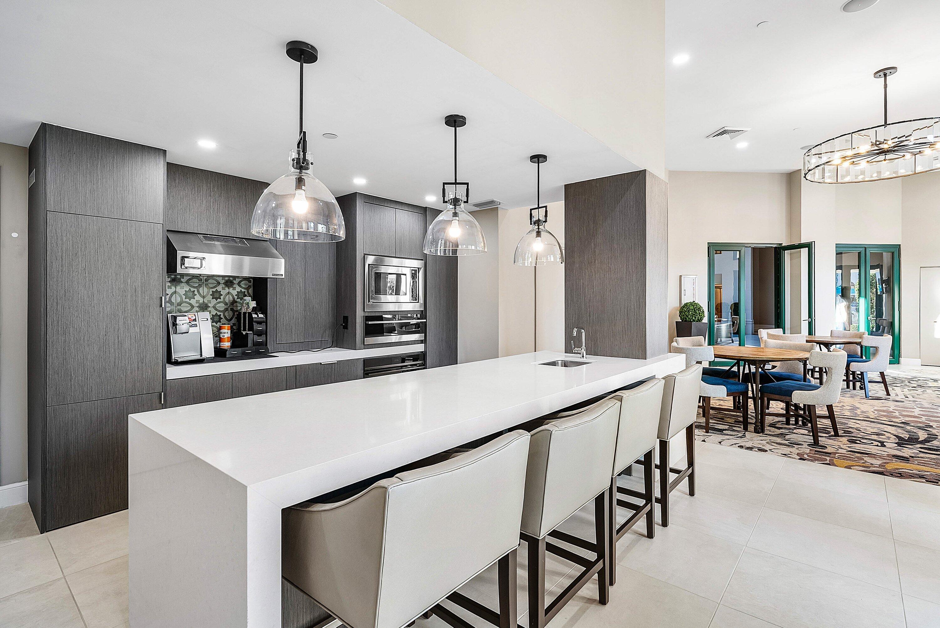 100 Southeast 5th Avenue, Unit 210 Boca Raton, FL 33432 - Photo 28 of 46 a large kitchen with a table and chairs