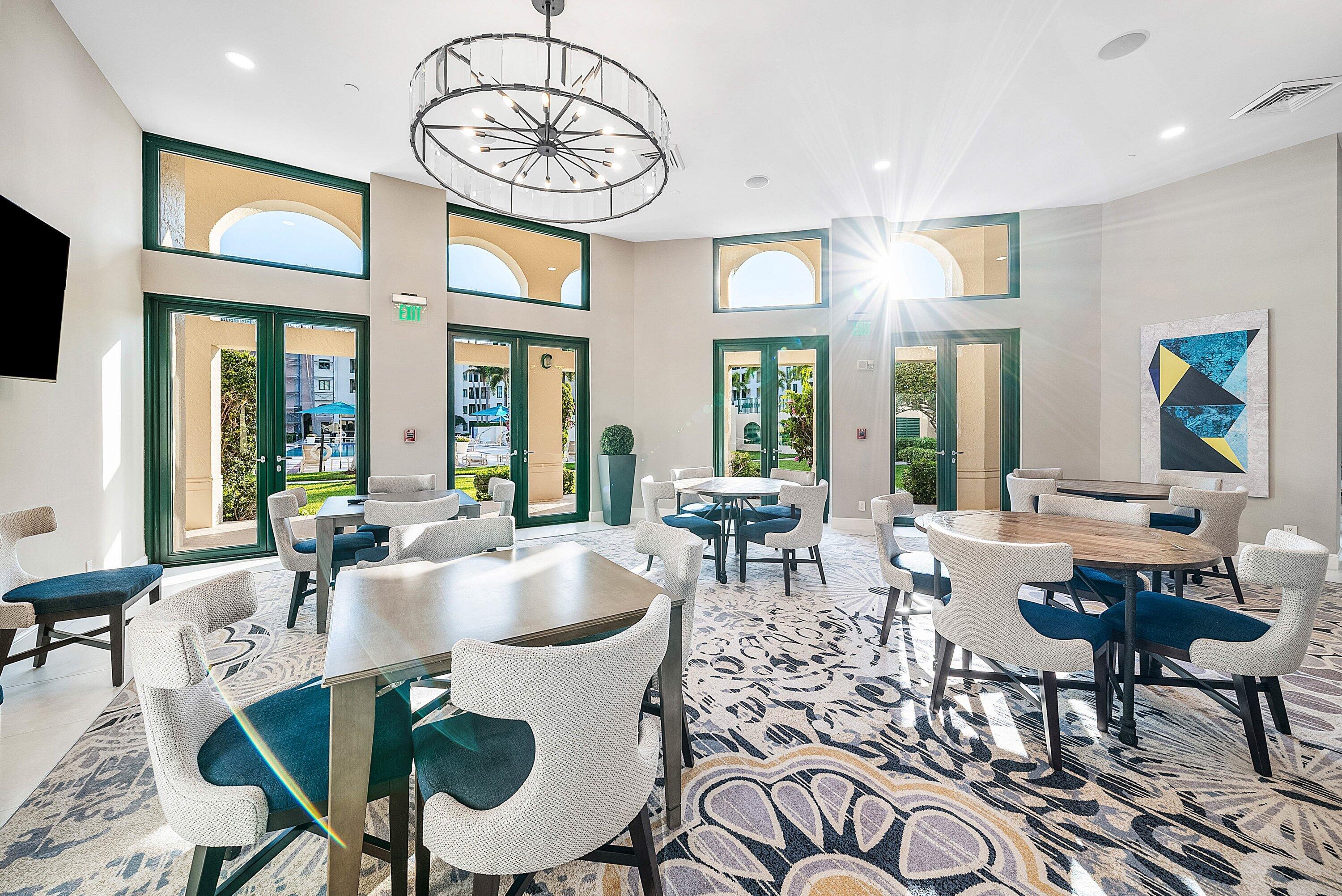 100 Southeast 5th Avenue, Unit 210 Boca Raton, FL 33432 - Photo 29 of 46 a dining room with furniture a rug and a chandelier