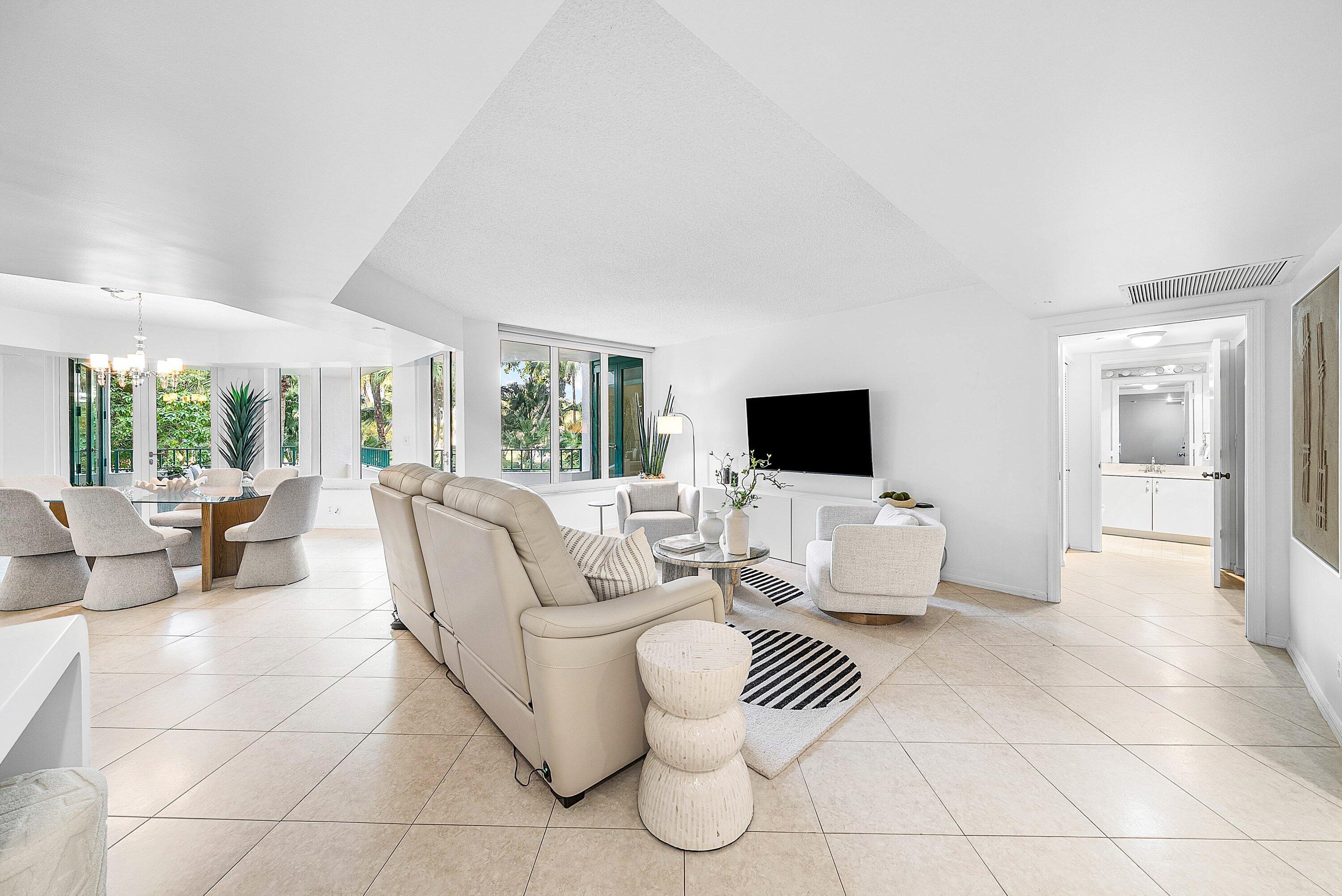 100 Southeast 5th Avenue, Unit 210 Boca Raton, FL 33432 - Photo 3 of 46 a living room with furniture and a flat screen tv