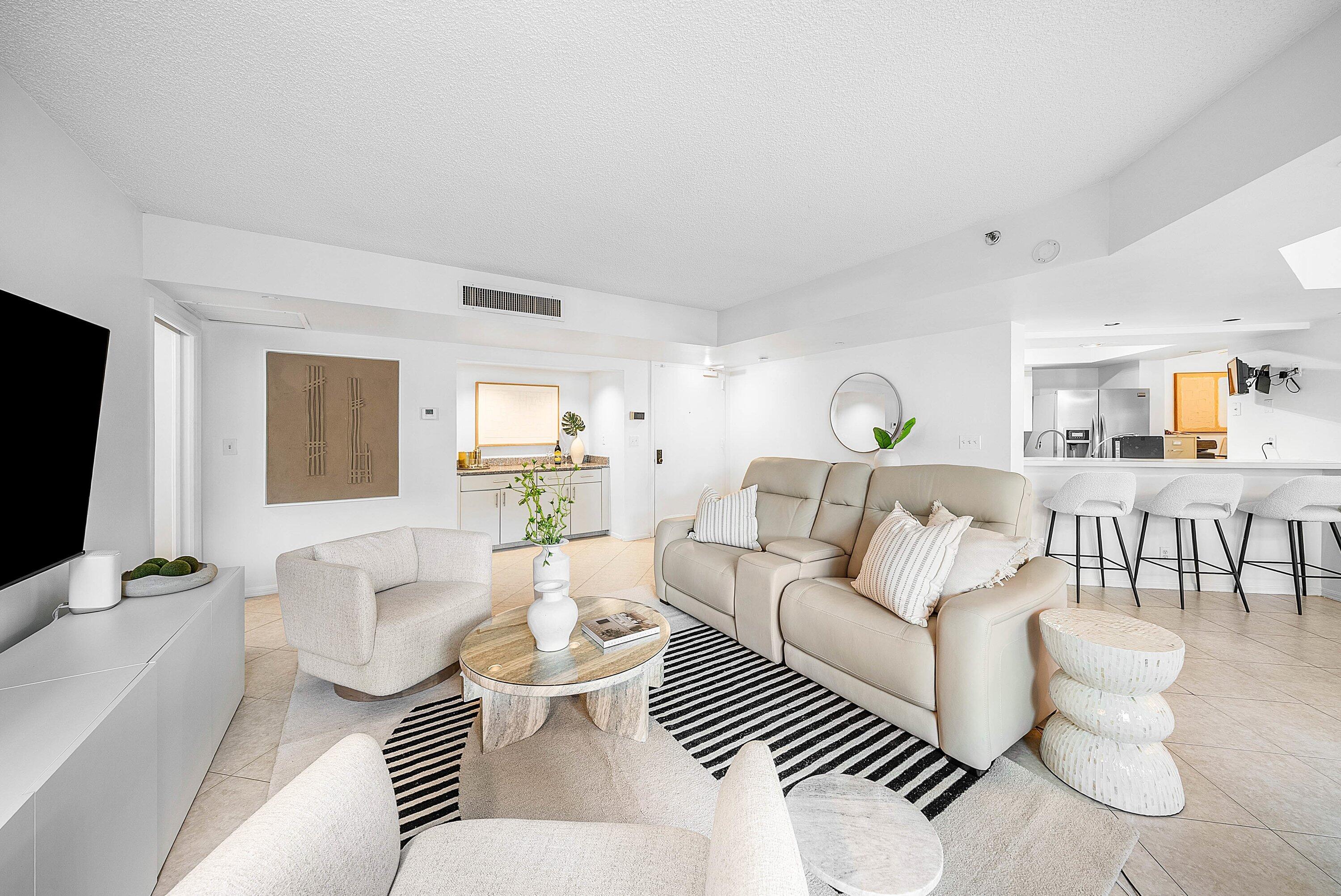 100 Southeast 5th Avenue, Unit 210 Boca Raton, FL 33432 - Photo 4 of 46 a living room with furniture and a flat screen tv