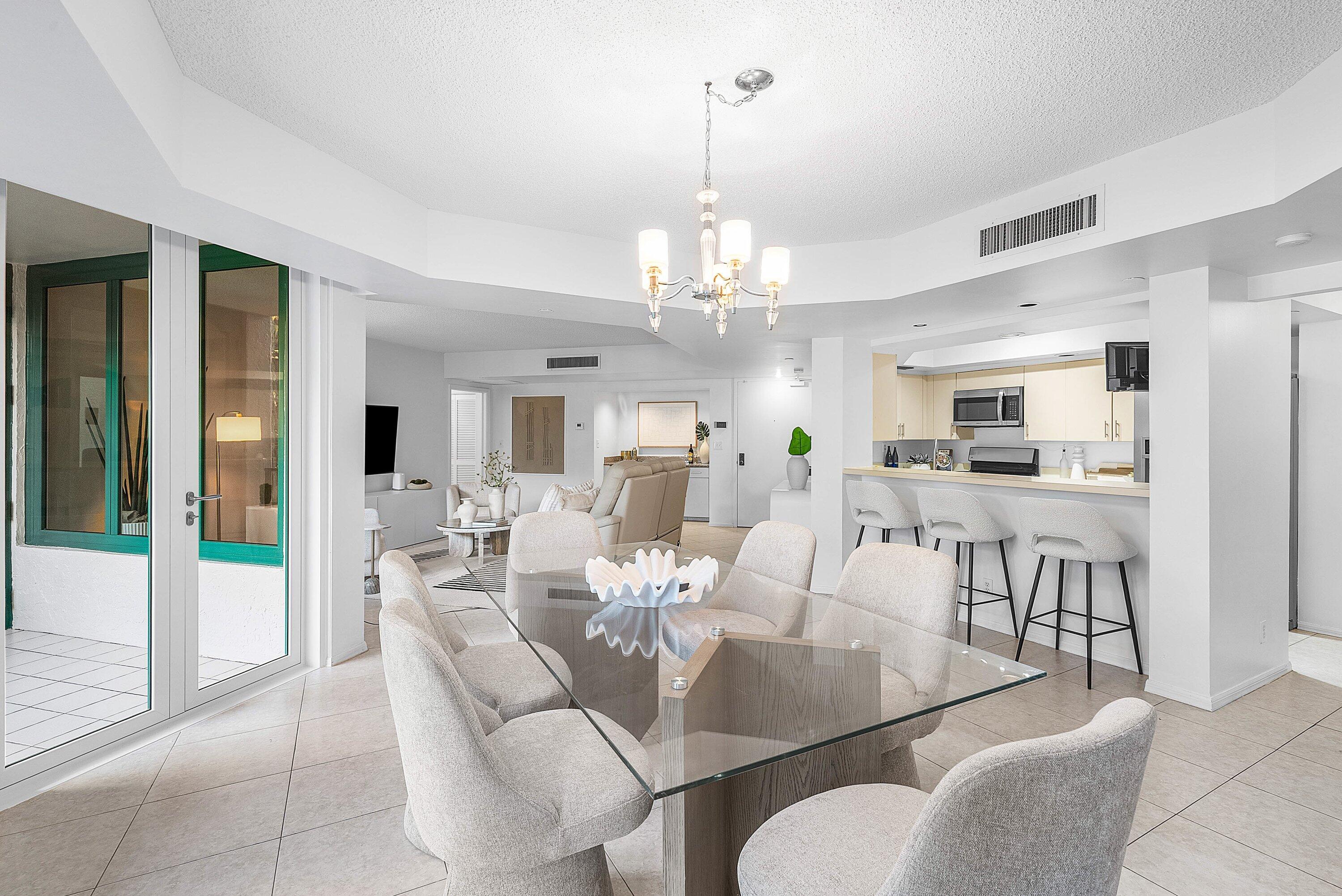 100 Southeast 5th Avenue, Unit 210 Boca Raton, FL 33432 - Photo 6 of 46 a view of a dining room and livingroom with furniture wooden floor a chandelier