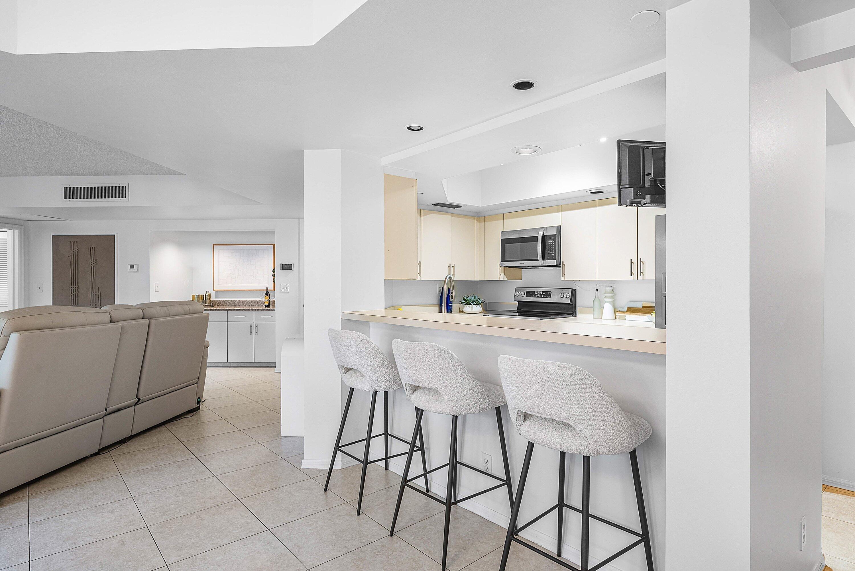 100 Southeast 5th Avenue, Unit 210 Boca Raton, FL 33432 - Photo 7 of 46 a kitchen with stainless steel appliances kitchen island granite countertop a sink and cabinets