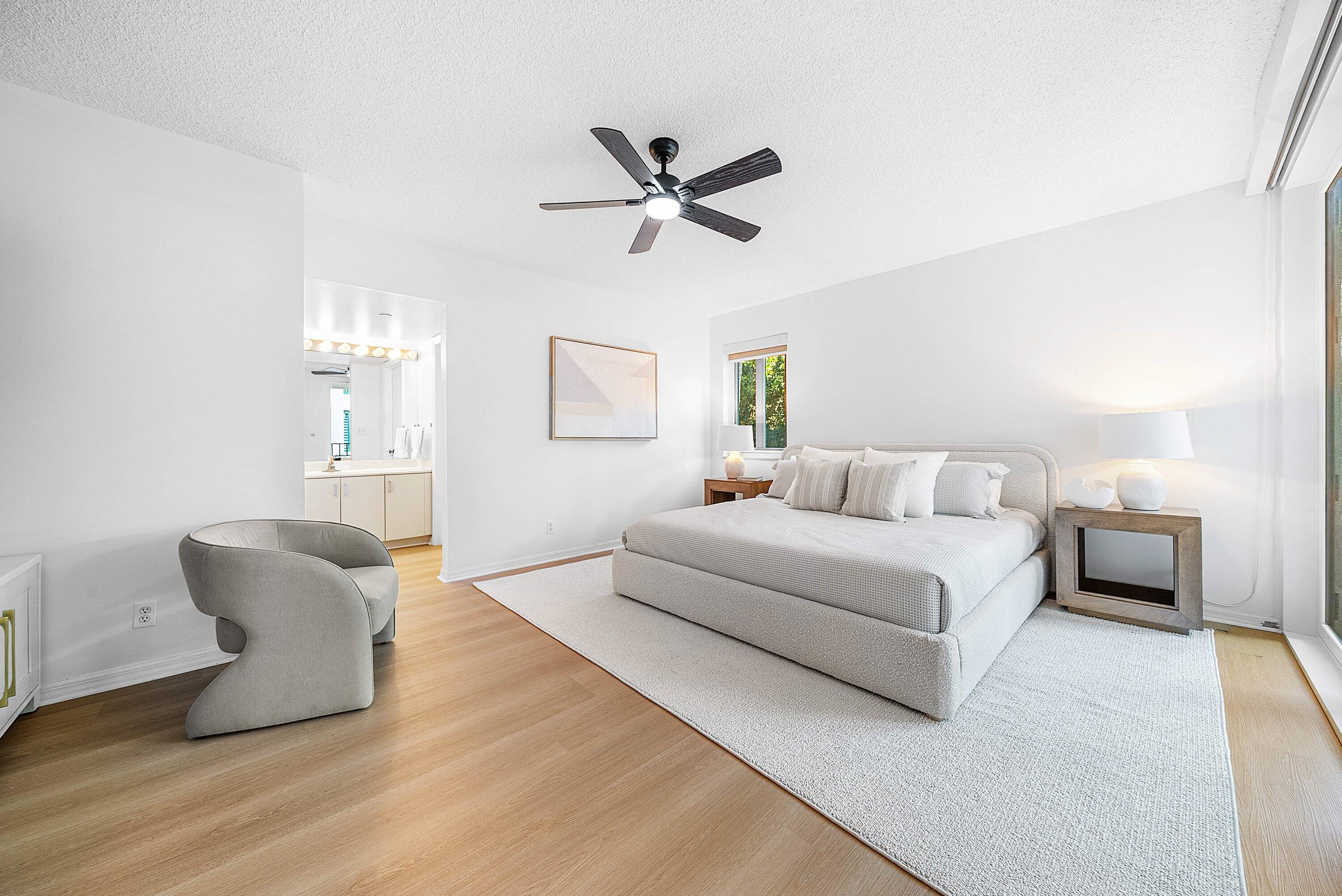 100 Southeast 5th Avenue, Unit 210 Boca Raton, FL 33432 - Photo 9 of 46 a bedroom with a bed and ceiling fan