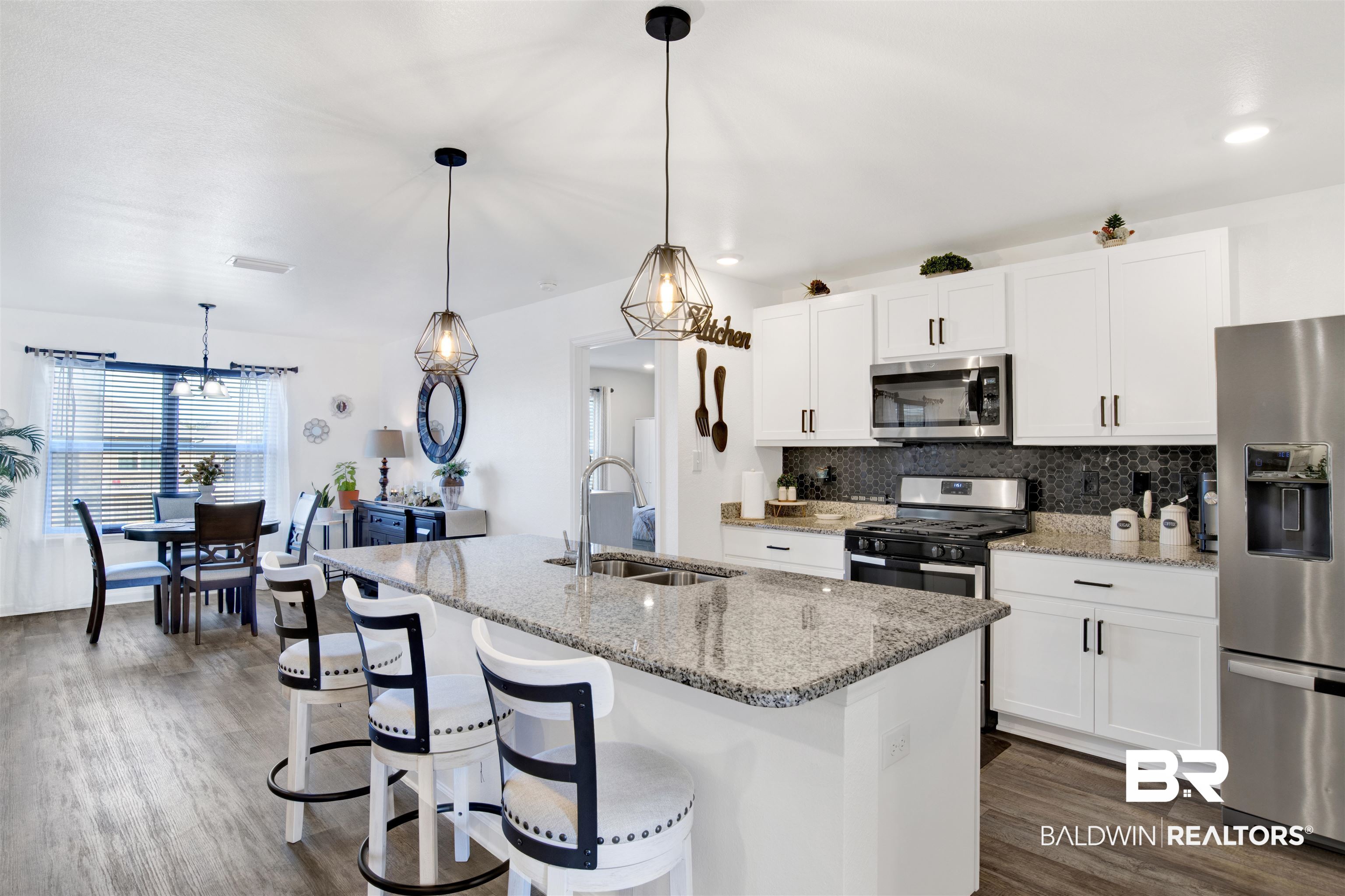 8102 Irwin Loop Daphne, AL 36526 - Photo 7 of 30 Kitchen with pendant lighting, stainless steel appliances, and a kitchen island with sink