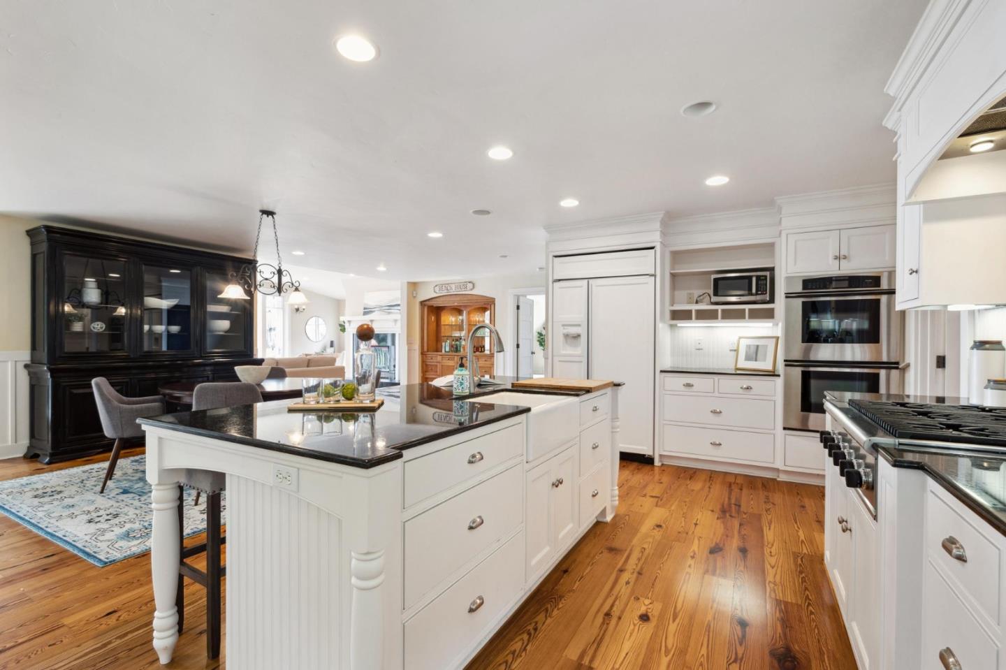 23865 Fairfield Place Carmel, CA 93923 - Photo 19 of 58 a kitchen with stainless steel appliances kitchen island granite countertop a stove and a sink