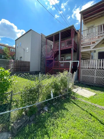 a view of a house with a small yard and plants