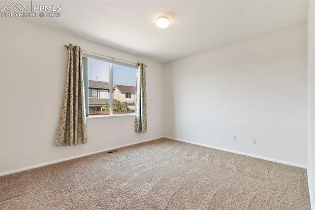 a view of an empty room and a window