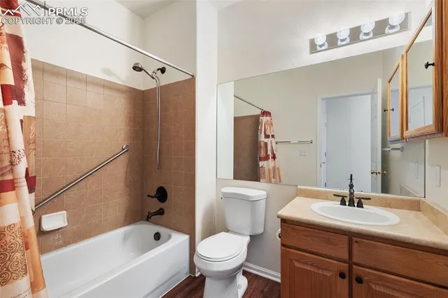 a view of an empty room with furniture and a window