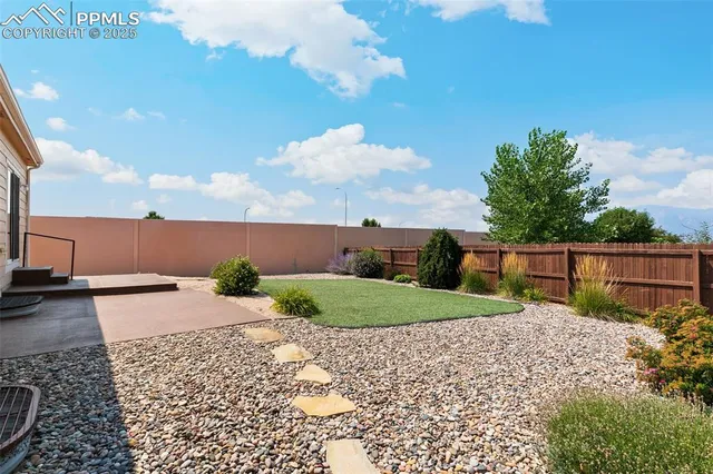 a view of a white house with a yard