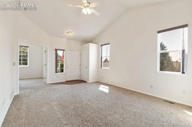 an empty room with windows and closet