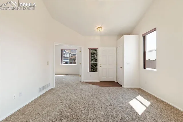 a view of an empty room with a window