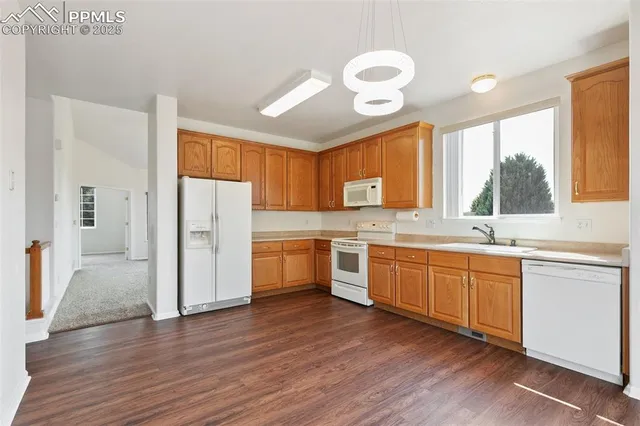 a kitchen with a refrigerator a sink and cabinets