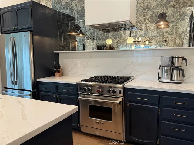 a kitchen with stainless steel appliances a stove and a refrigerator