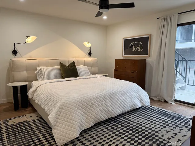 a bedroom with bed and a night stand