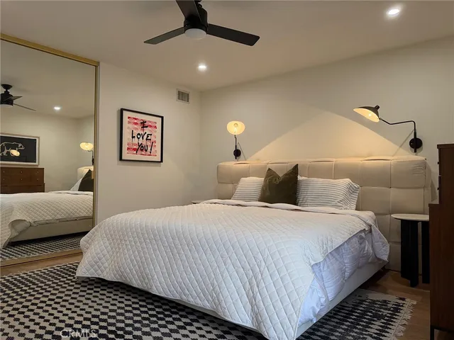 a bedroom with a bed and a couch
