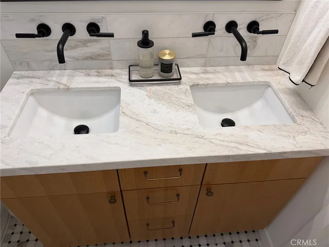 a bathroom with a sink and mirror