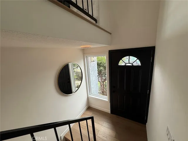 a view of a livingroom with wooden floor and a window